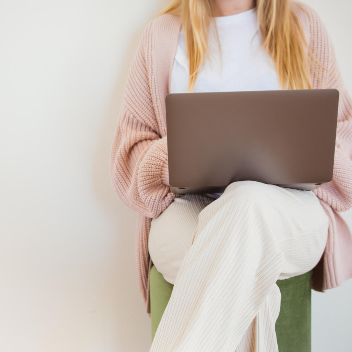 Career Support for Job Seekers Career Support for Job Seekers - Woman sitting on a stool, legs crossed, with an open laptop on her lap.